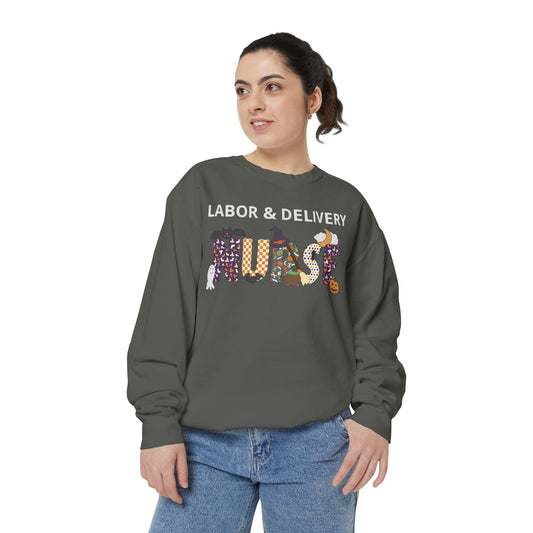 Pepper (dark) crewneck sweatshirt on a model, personalized Halloween Nurse design with nurse specialty text above a 'NURSE' wordmark styled with a pumpkin, witch hat, ghost, and bat