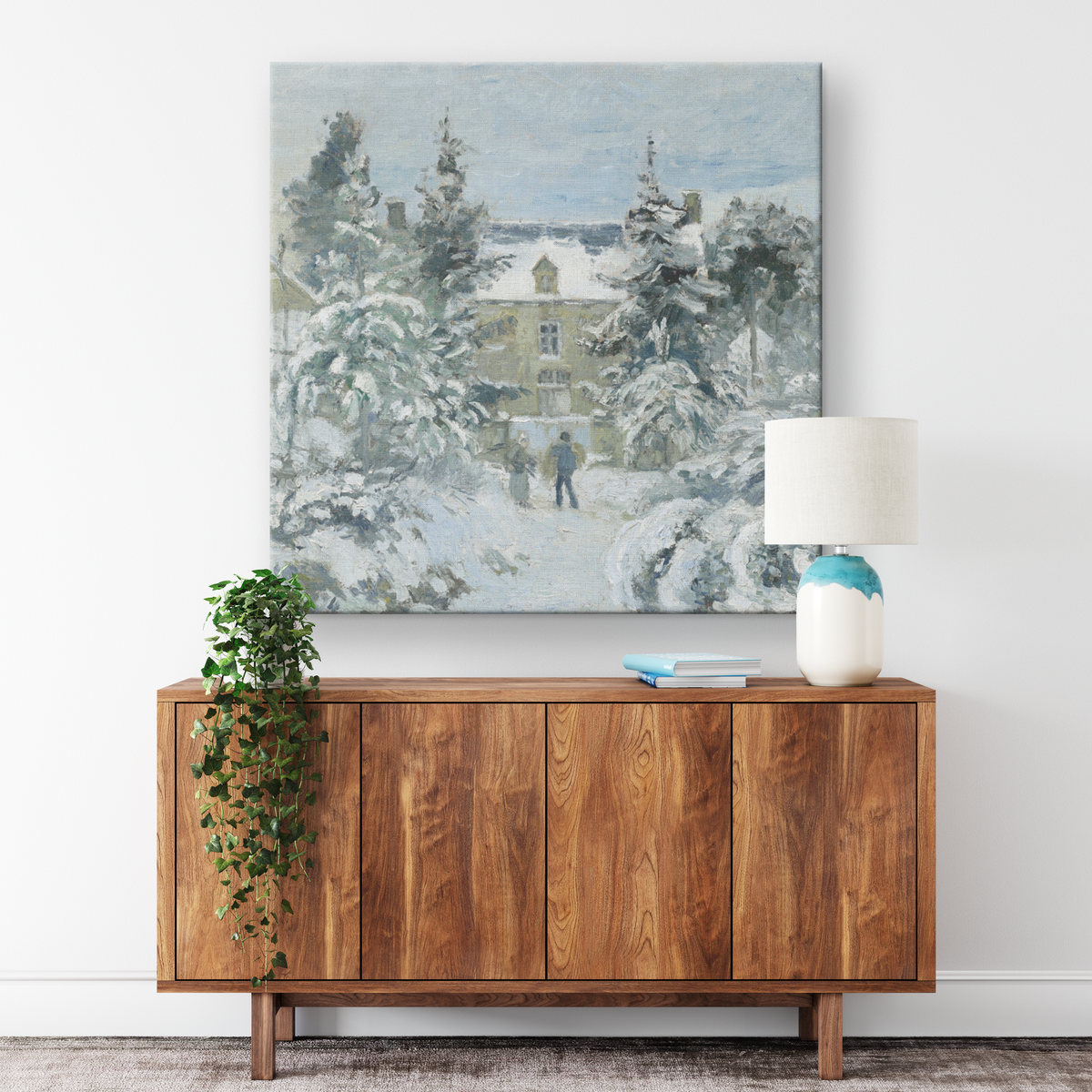 Snowy cottage winter scene canvas wrap displayed above a wood console table