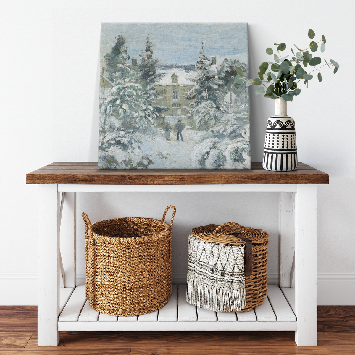 Snowy cottage winter scene canvas wrap displayed in a smaller room setting
